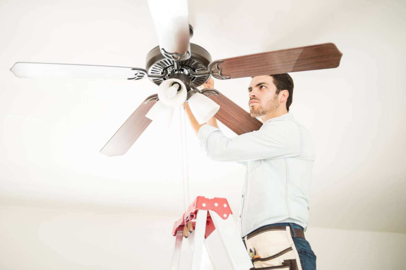 ACS worker installing brown ceiling fan