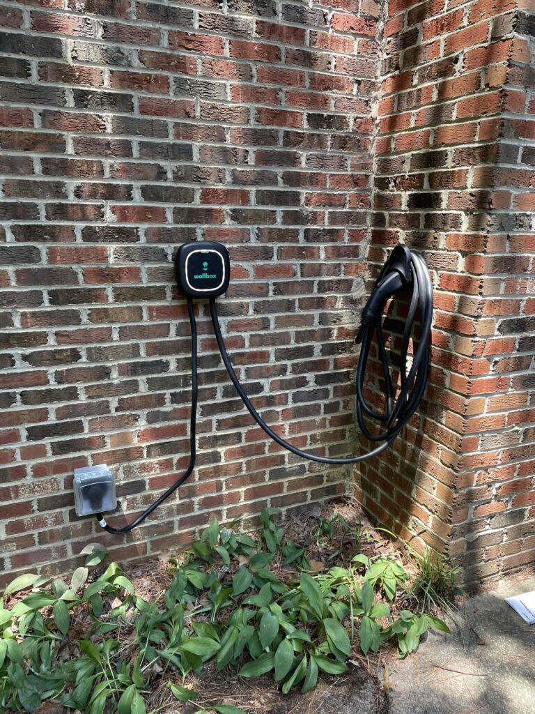 Charge electric vehicle outside on home.